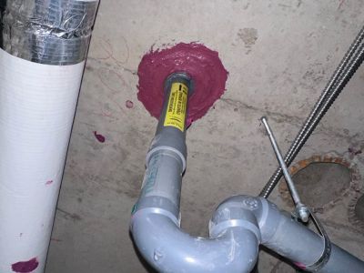 Firestop caulk at pipe penetration Red firestop caulk sealing a pipe penetration, installed by Metro Insulation in a Toronto high-rise