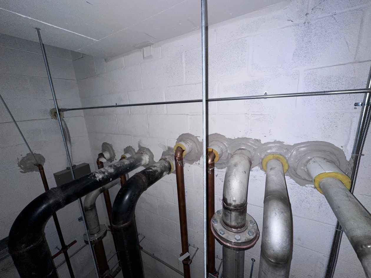 67cddcca7f64cc2f282b06708adadc77739a2824dbd64ebab12d4344b13d7c17 Firestopping sealant around mechanical pipe penetrations installed by Metro Insulation in a Toronto high-rise
