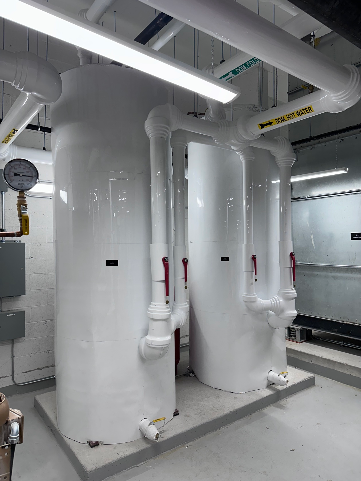 Hot water tanks after insulation with white PVC jacketing